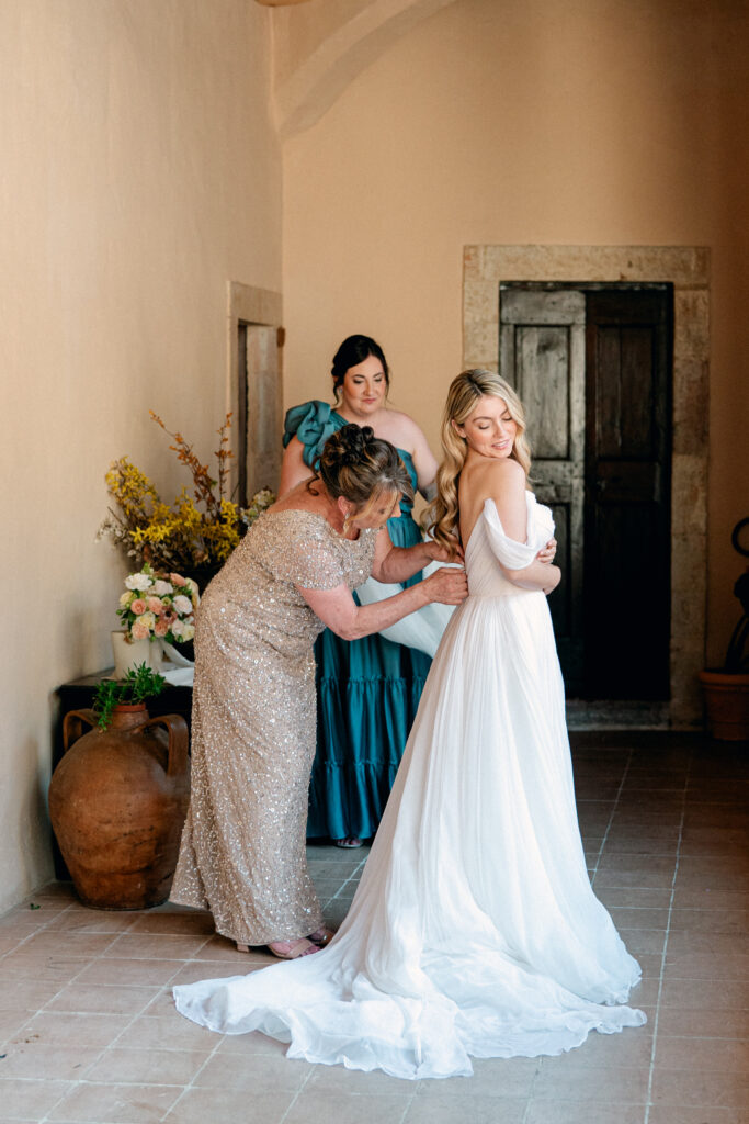 Bride getting dressed, Abbazia San Pietro in Valle wedding, image taken by Kelley Williams a wedding photographer in Umbria Italy