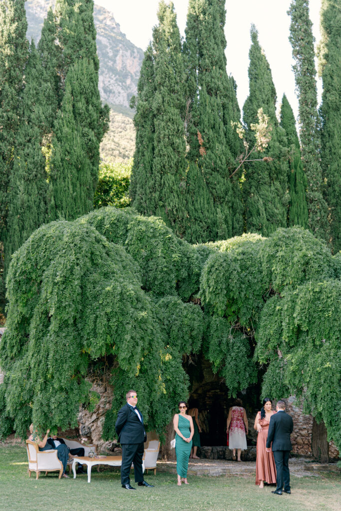 Guests waiting for the ceremony to start in the shade, Abbazia San Pietro in Valle wedding, image taken by Kelley Williams a wedding photographer in Umbria Italy