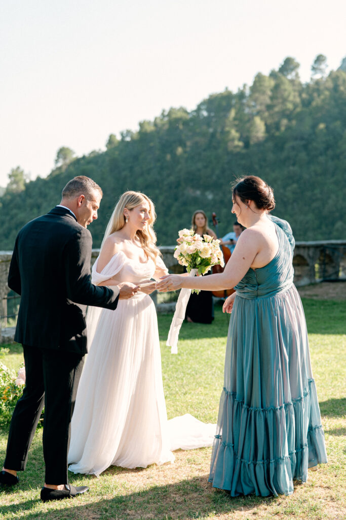 Maid of honor handing over the ring to the couple, Abbazia San Pietro in Valle wedding, image taken by Kelley Williams a wedding photographer in Umbria Italy