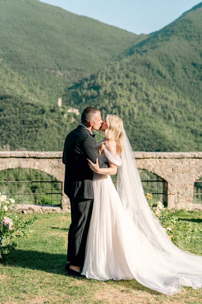 The first kiss as husband and wife, Abbazia San Pietro in Valle wedding, image taken by Kelley Williams a wedding photographer in Umbria Italy