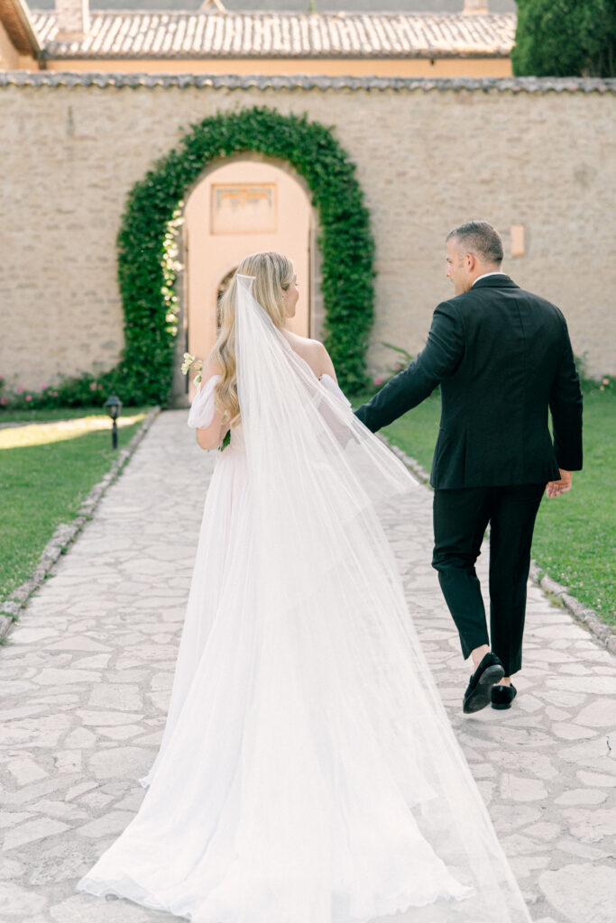 The wedding couple walking out from the ceremony, Abbazia San Pietro in Valle wedding, image taken by Kelley Williams a wedding photographer in Umbria Italy