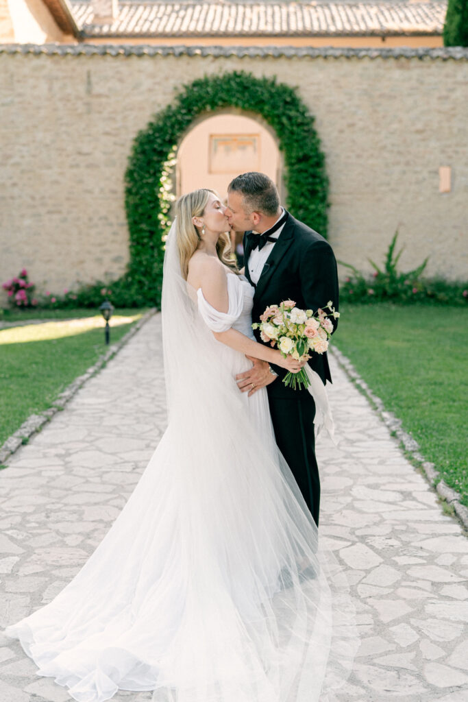 Bride and groom kissing, Abbazia San Pietro in Valle wedding, image taken by Kelley Williams a wedding photographer in Umbria Italy