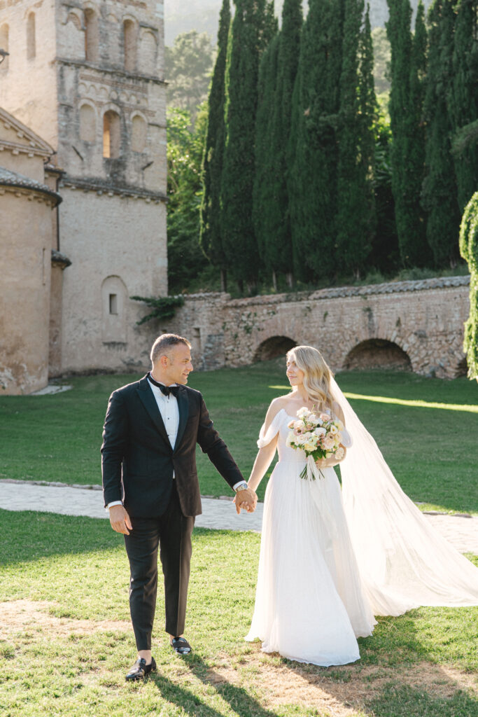 Bride and groom walking toward the camera, Abbazia San Pietro in Valle wedding, image taken by Kelley Williams a wedding photographer in Umbria Italy