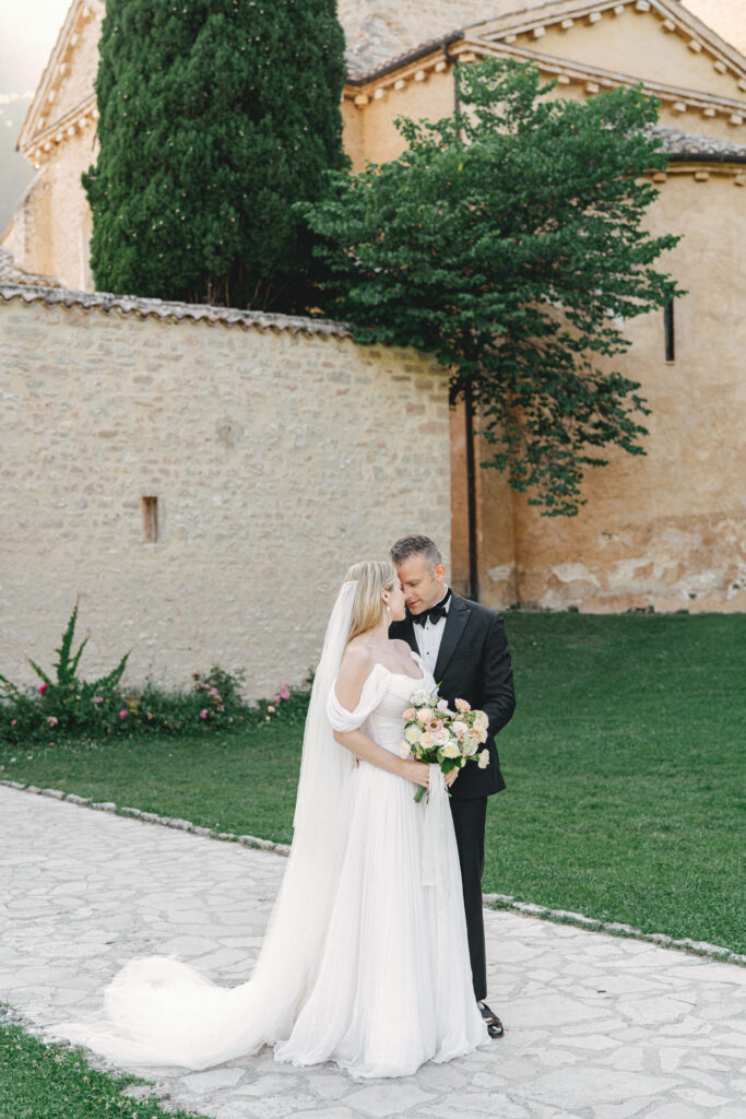 Bride and groom in front of Abbazia San Pietro in Valle wedding, image taken by Kelley Williams a wedding photographer in Umbria Italy
