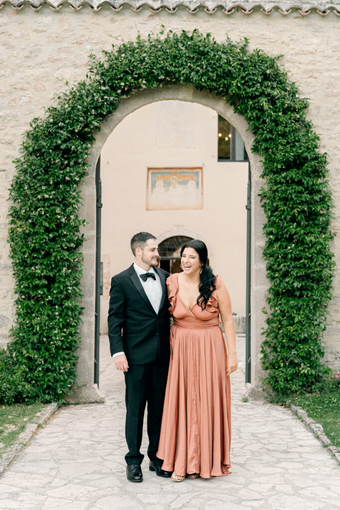 Portrait of wedding guests in front of an archway covered in greenery, Abbazia San Pietro in Valle wedding, image taken by Kelley Williams a wedding photographer in Umbria Italy