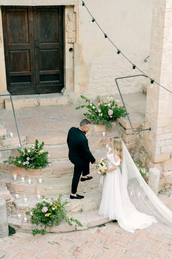 Wedding couple going up the stairs, Abbazia San Pietro in Valle wedding, image taken by Kelley Williams a wedding photographer in Umbria Italy