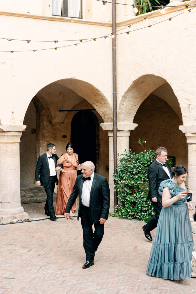 Wedding guests walking into the wedding reception, Abbazia San Pietro in Valle wedding, image taken by Kelley Williams a wedding photographer in Umbria Italy
