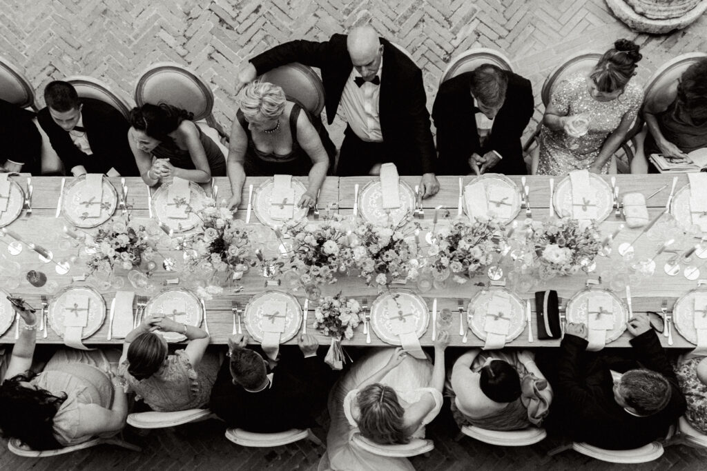 Overhead view of all the wedding guests sitting down for dinner, Abbazia San Pietro in Valle wedding, image taken by Kelley Williams a wedding photographer in Umbria Italy