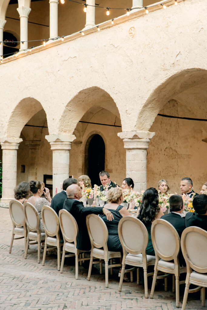 View of the wedding guests chatting during dinner, Abbazia San Pietro in Valle wedding, image taken by Kelley Williams a wedding photographer in Umbria Italy