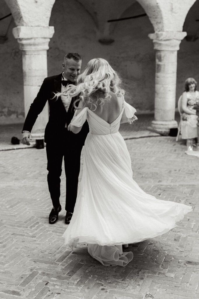 Couple doing their first dance, the photo is in black and white, Abbazia San Pietro in Valle wedding, image taken by Kelley Williams a wedding photographer in Umbria Italy
