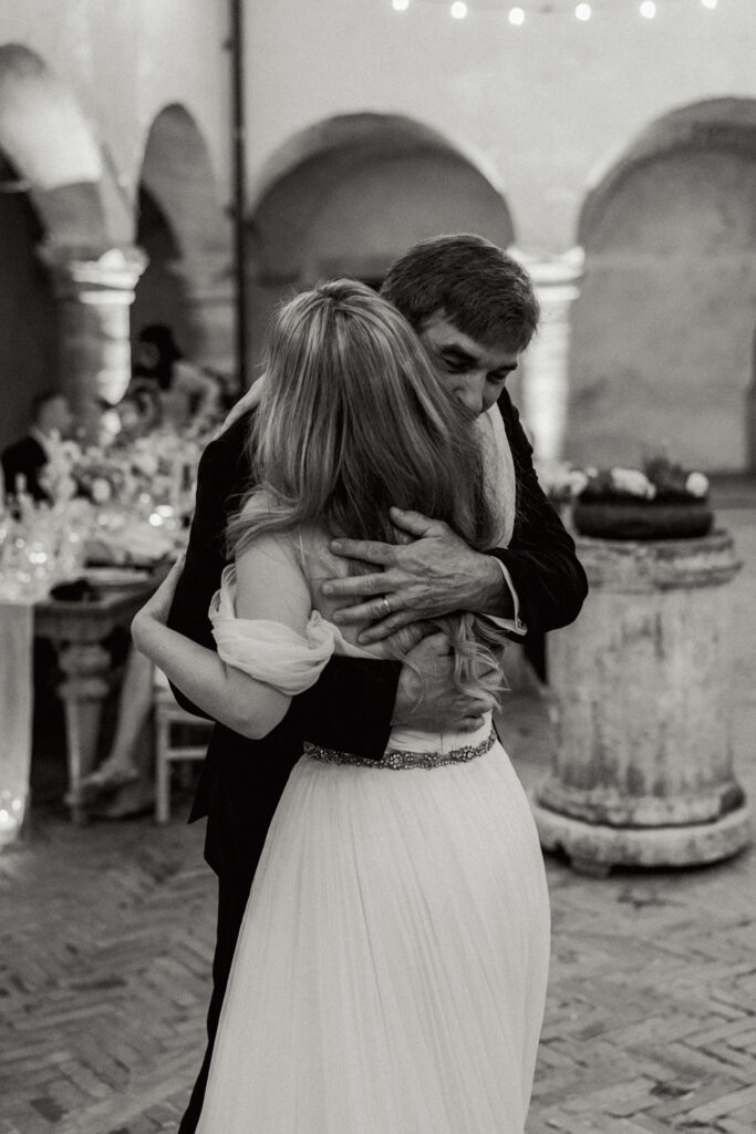 Bride hugging her dad, Abbazia San Pietro in Valle wedding, image taken by Kelley Williams a wedding photographer in Umbria Italy