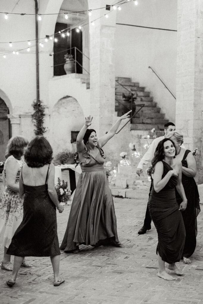 Wedding guests dancing on the dance floor, Abbazia San Pietro in Valle wedding, image taken by Kelley Williams a wedding photographer in Umbria Italy